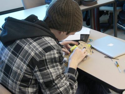 student hard at work on a robotics item