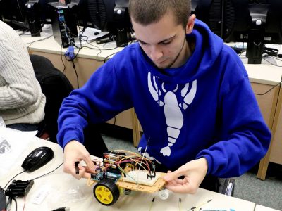 student working on a robot