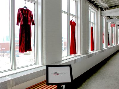 red dresses hanging from windows inside hallway by windows Brock University