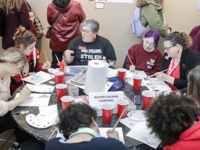 People sit around a table, participating in a 