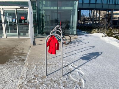 red dress hanging from a bike rack outside Brock University