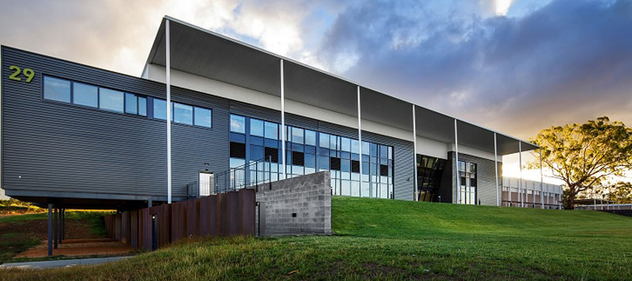 A modern gray and white building on the University of Canberra campus.