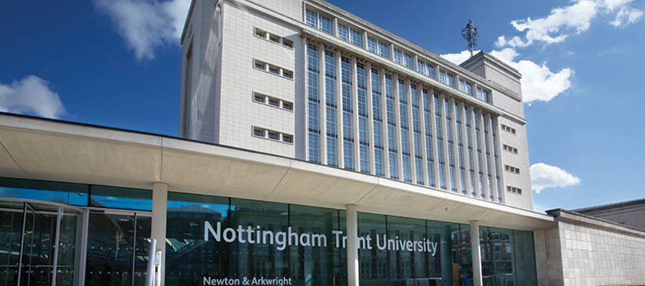 A modern white building stands against a blue sky at Nottingham Trent University in England.