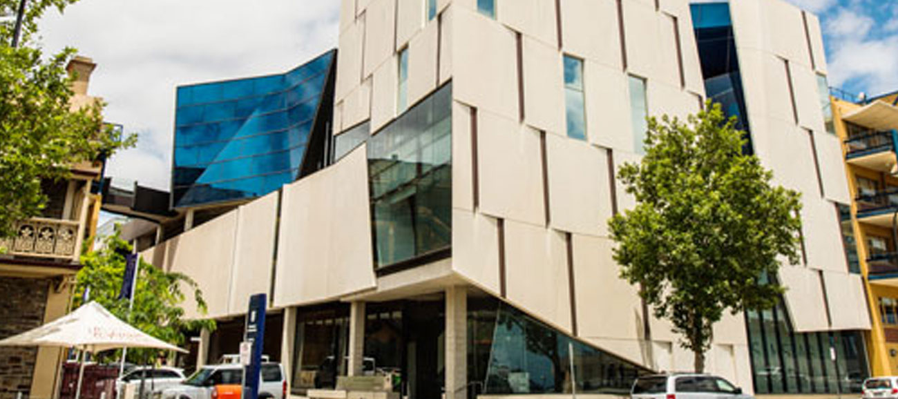 A modern white building on the campus of University of South Australia.