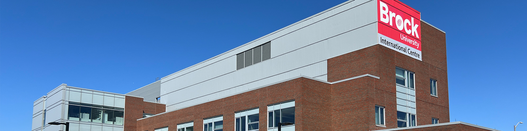 A photo of the Brock International Centre building in front of a blue cloudless sky.