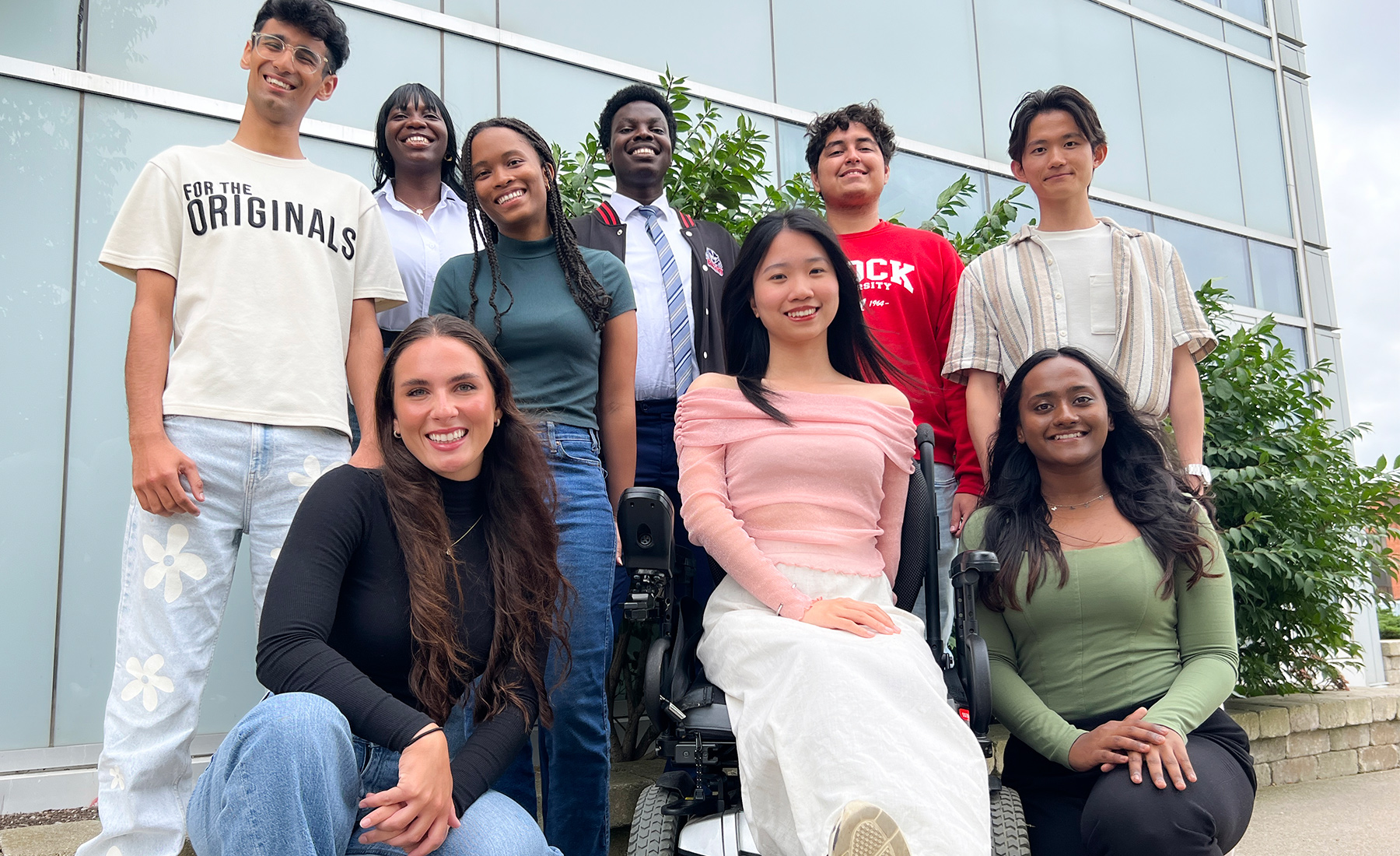 Brock's International Student Ambassadors pose for a group photo outside the Brock International Centre. 