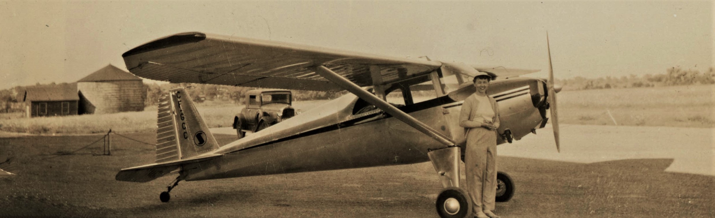 Dorothy Rungeling standing beside her first airplane