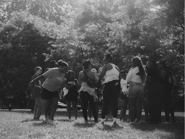 Women stretch their bodies in preparation for a run.
