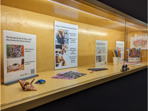 The April Learning Commons display case is full of de-stressing activities like colouring and crafting supplies.