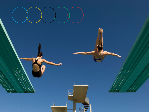 Women dive into a pool