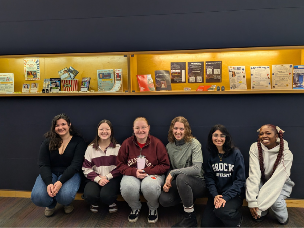 Student Library Assistants pose at their exhibit
