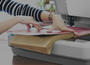 A woman scans a book