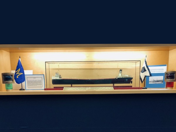 A ship model and nautical flags