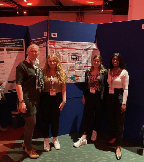 Lab members in front of their poster presentation