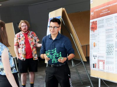 Sebastien Duguay, a first-year Physics student presents their research.