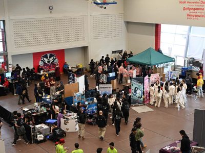 Robotics competition pit area at Brock University featuring booths and students