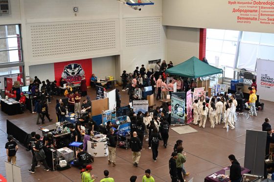Robotics competition pit area at Brock University featuring booths and students