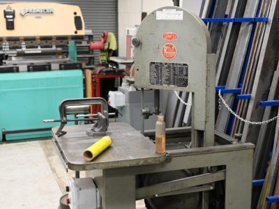Roll-in bandsaw with material stock in the background
