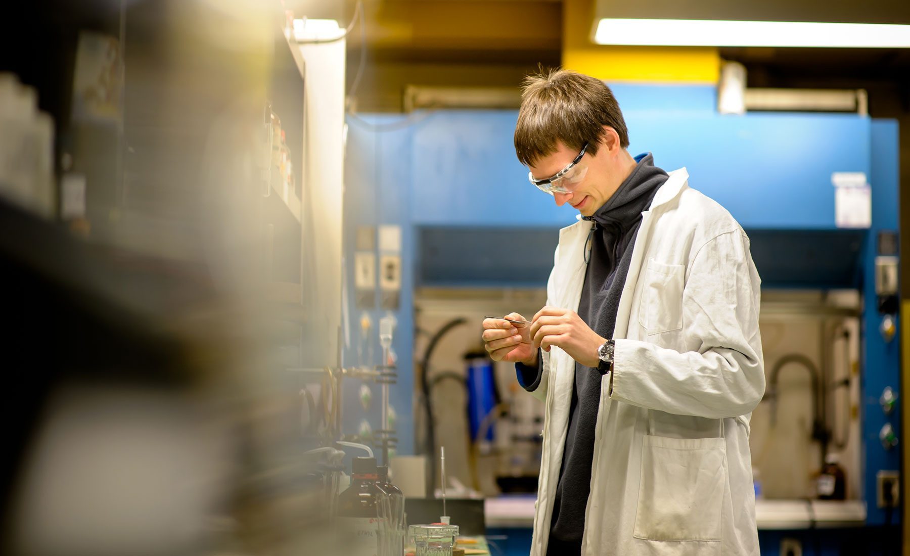 Student in lab inspecting a chemical