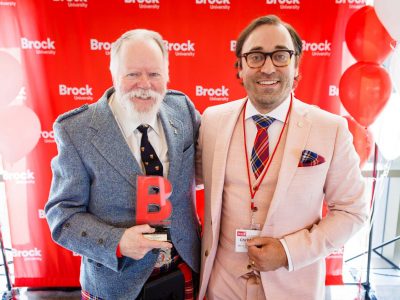 Photo of David Mackenzie accepting the David Betzner Award during the 2026 Alumni Awards Celebration