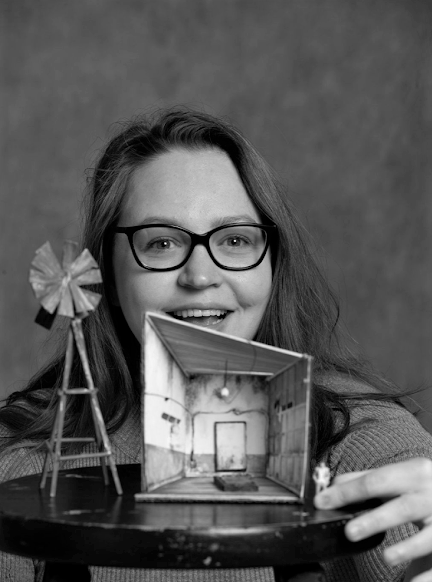 Photo of Emily Dotson with a maquette.