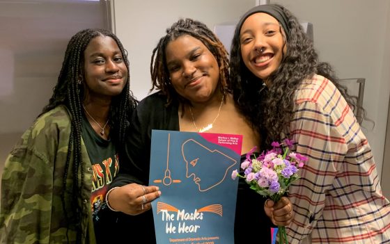 MakaylaFinn-1600x1004 three women smiling, the middle one holding a poster for the One Act Plays festival
