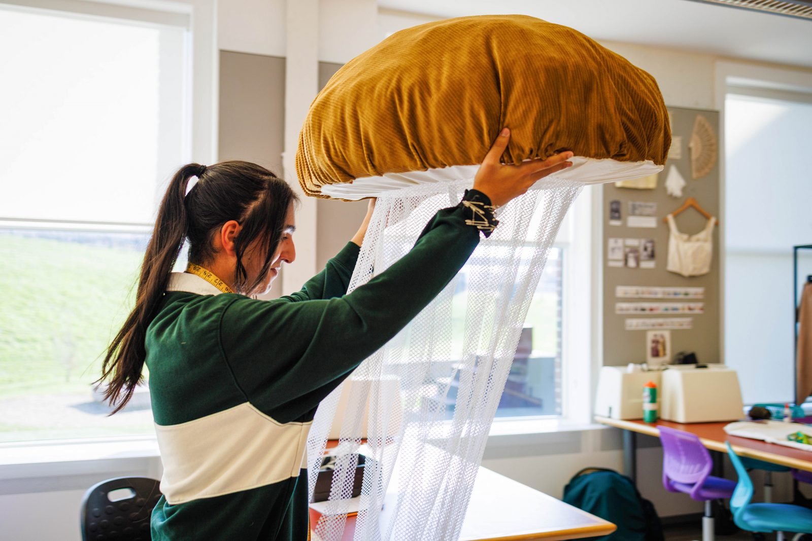 Dramatic arts student Nav Brar works on a mushroom costume in the Costume Shop.