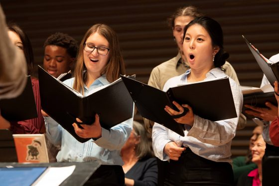 Photo of students singing in a choir workshop.