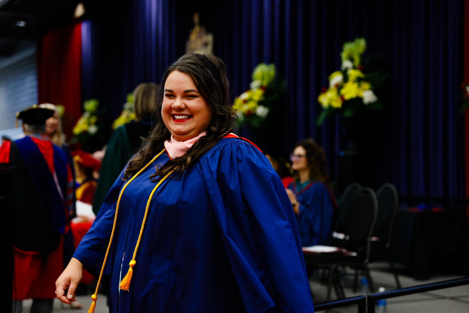 Photograph of Samantha Bowman wearing graduation robe at Spring Convocation 2024