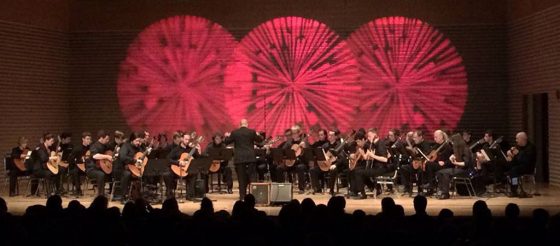 might guitar orchestra on stage