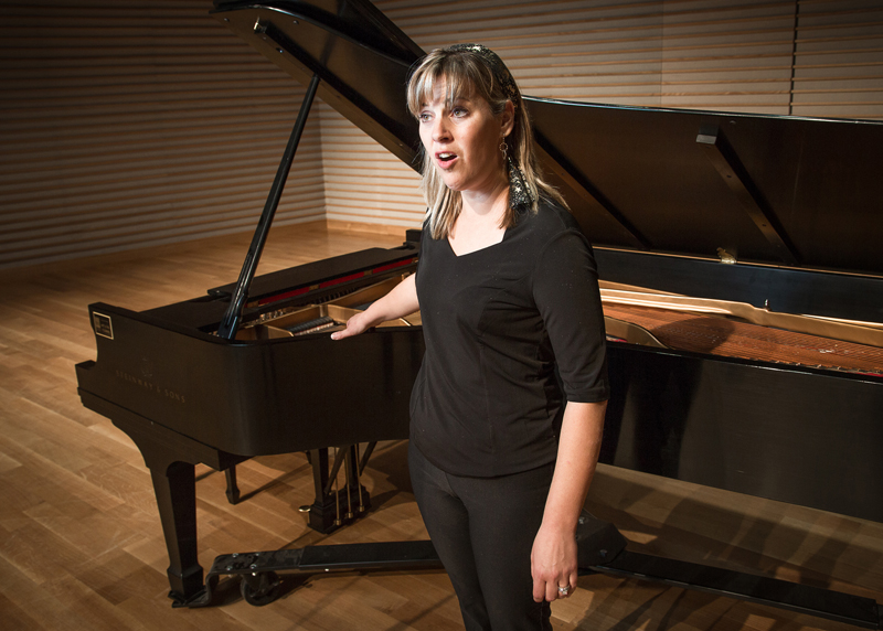 a pianist next to her piano