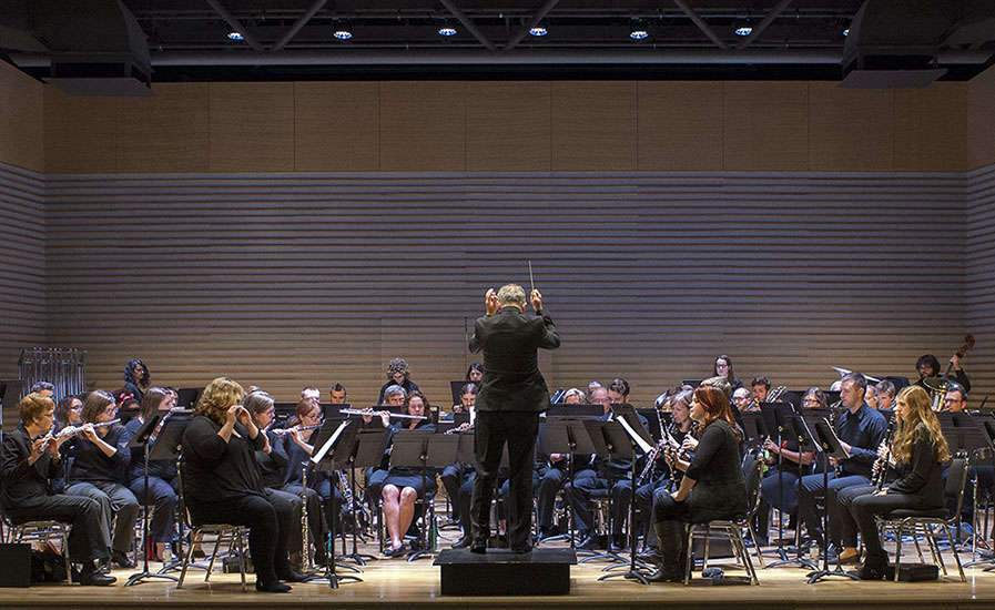 Conductor and music students on stage