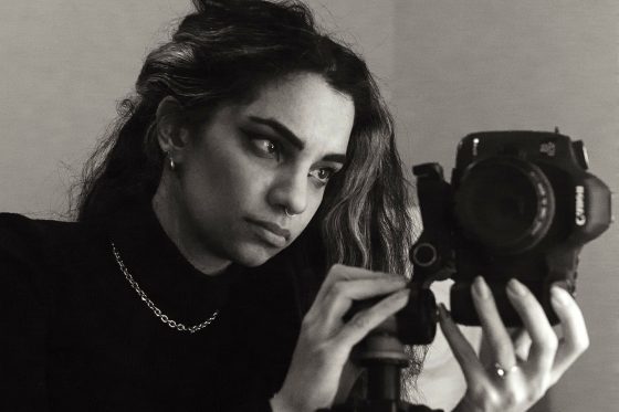 Gallery-5_contrast_adj_th Woman looking into the viewfinder of a cannon camera