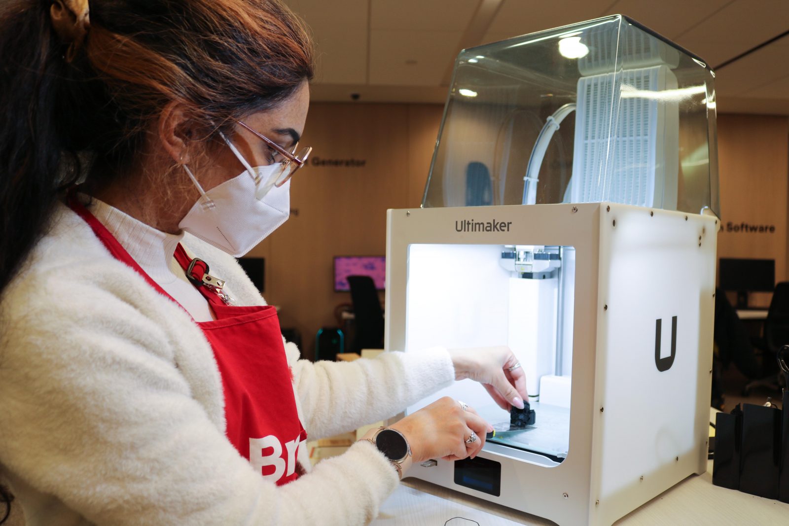 Christy Mitchell removes a model from a 3D printer
