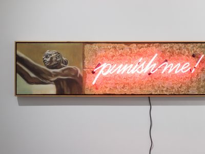 Neon sign reading punish me with the portrait of a sculture