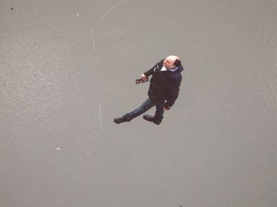 top view of a man walking on a grey background painting
