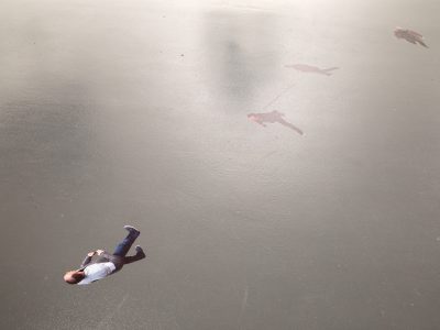 top view of a man walking on a grey background painting
