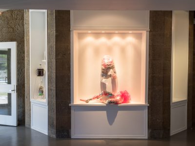 lighted exhibit of a doll on a small stage