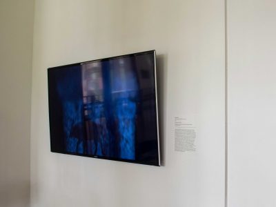 tv screen hanging on wall with artwork on screen