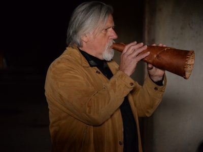 Jim Watkins playing a leather flute