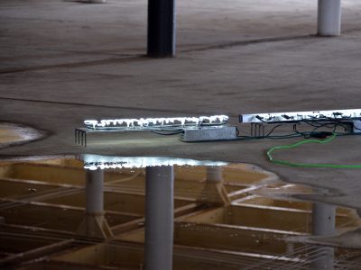 light neon signs on edge glowing white in an industrial space