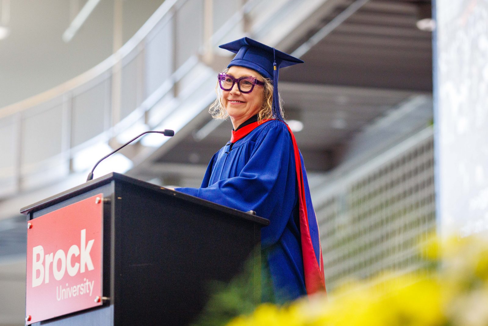Photo of Donna Szoke in cap and gown giving convocation speech.
