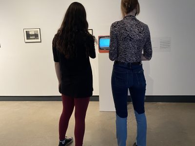 2 gallery attendees viewing projection on a screen