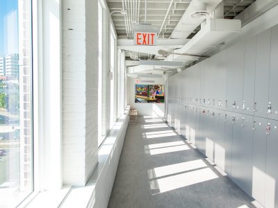 lockers in a hallway with windows on opposite side