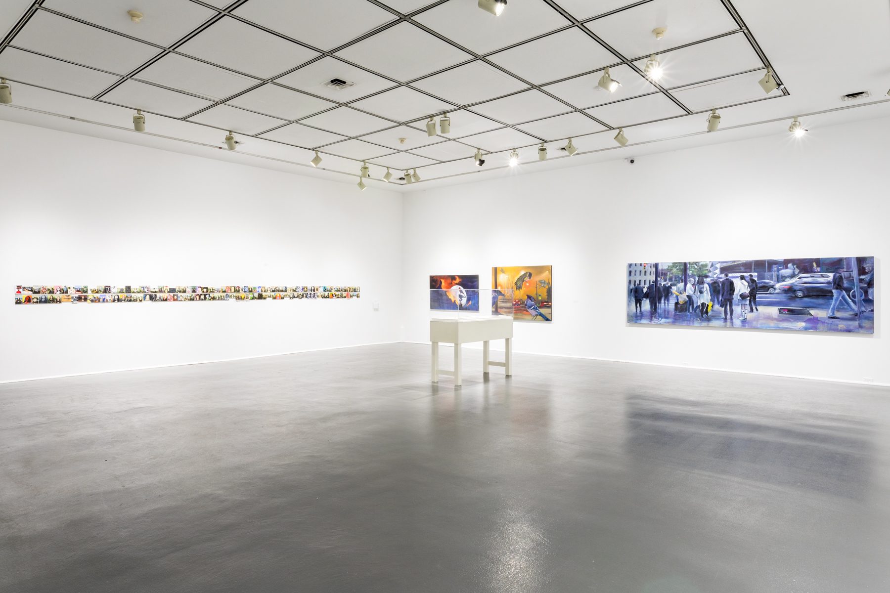 interior view of an artgallery with large colourful paintings hanging on wall