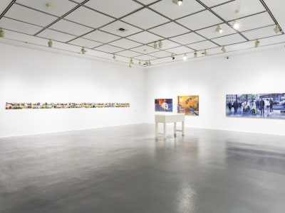 interior view of an artgallery with large colourful paintings hanging on wall