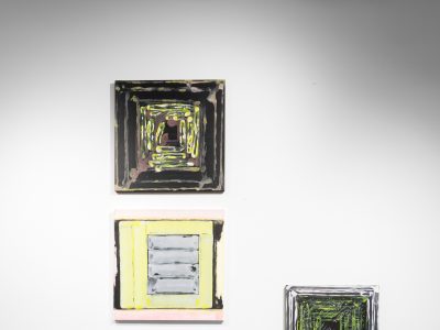 group of 4 prints hanging on a gallery wall