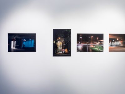 4 paintings hanging on gallery wall