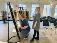 Photo of VISA faculty member offering feedback to a participant in the VISA drawing room.