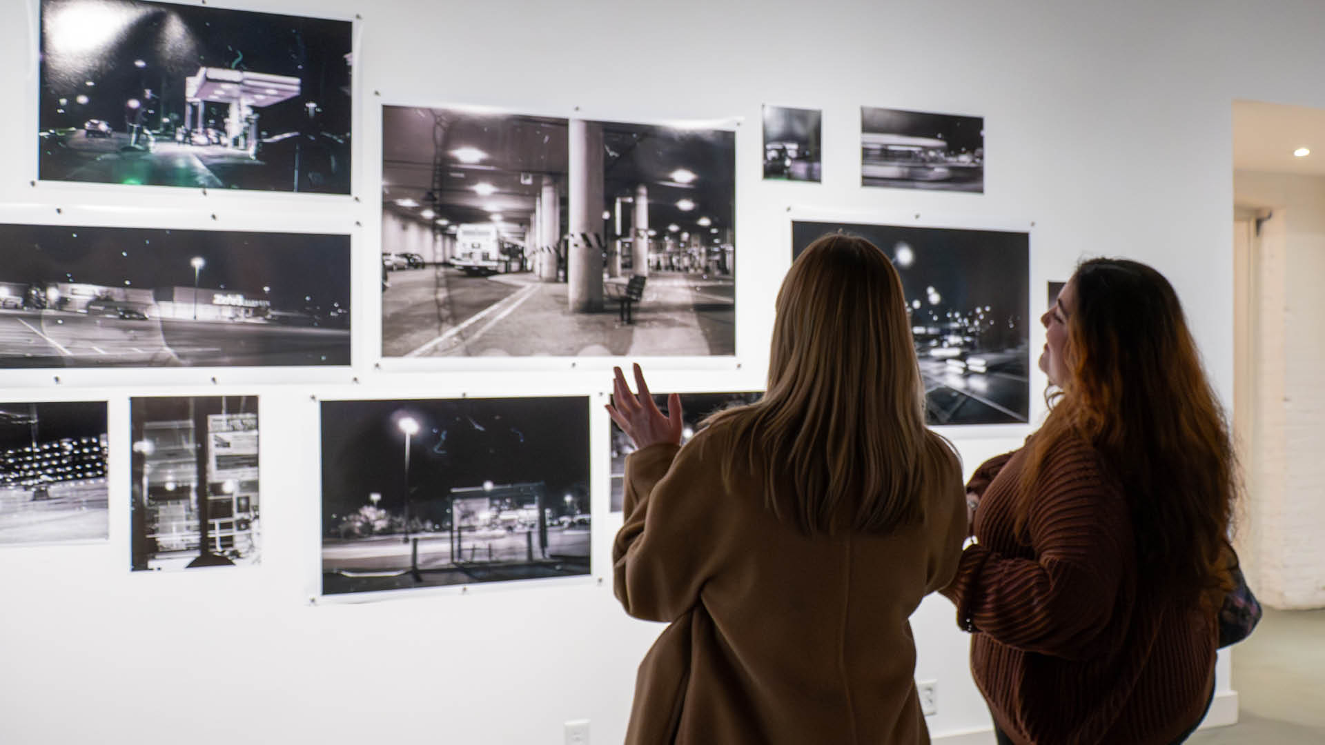 Two people look at art. 
